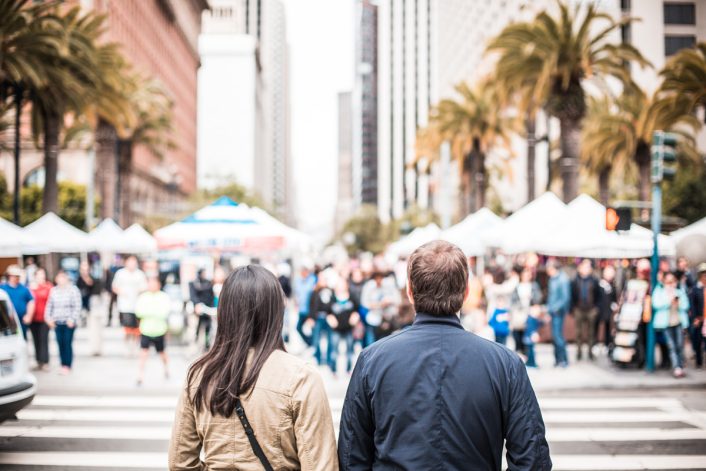 Young Couple Looking on the Other Side of the Crosswalk